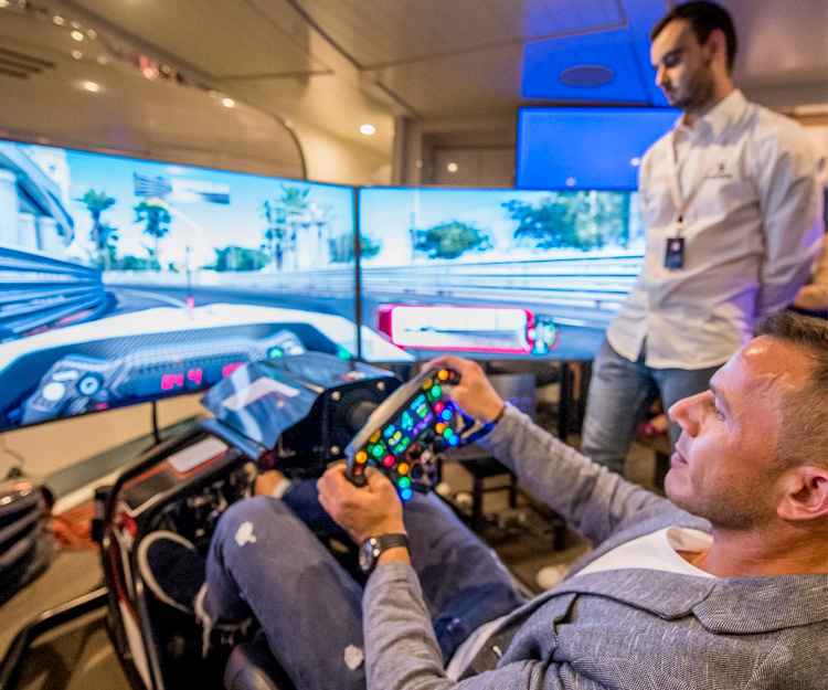 Men playing on a sim racing rig