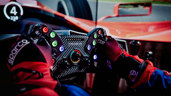 A man driving a MOZA racing sim racing wheel