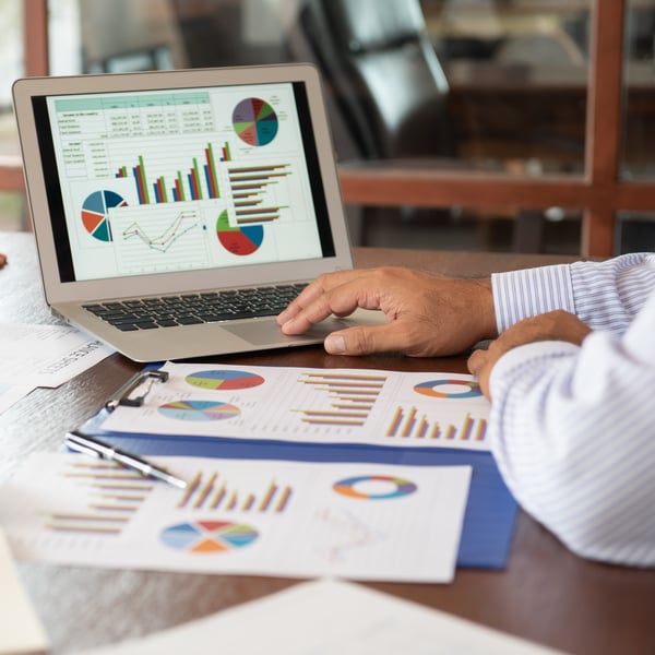 Computer and corporate documents with pie charts graph