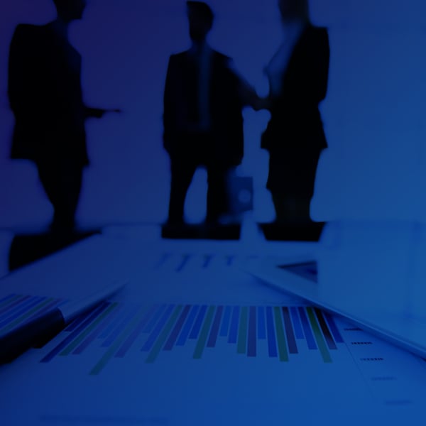 Three business people talking with chart on a table