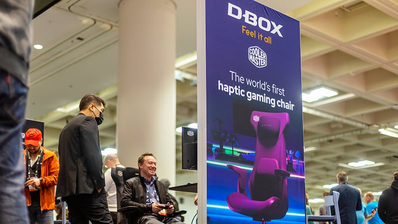 A GDC attendee games on a D-BOX haptic chair