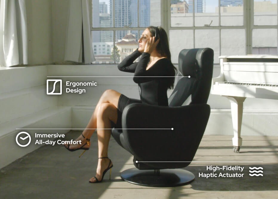 A woman sits in the D-BOX VIBE haptic chair