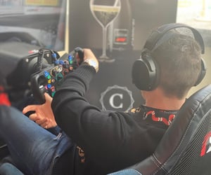 A man sitting on a sim racing rig