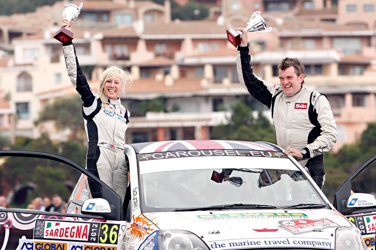 Louise Cook hoisting the 2012 WRC trophy