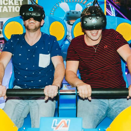 Two man experiencing VR on an attraction rollercoaster seat