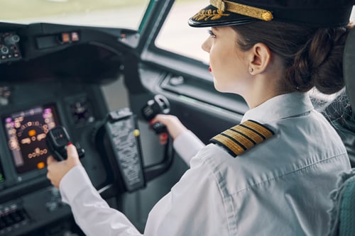 Serious concentrated female pilote in a flight simulator