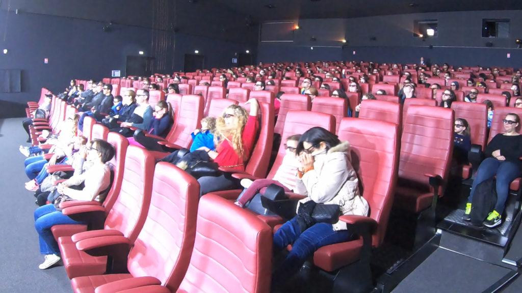 An auditorium of people enjoying a 4D experience